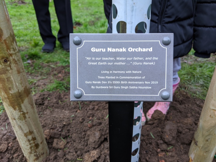 Special plaque naming the orchard the Guru Nanak Orchard.
